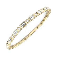 14 Karat Yellow Gold Flexible Bangle Bracelet With 9=1.63Tw Baguette Diamonds And 8=0.26Tw Round Diamonds 
Length/Size: 6.25