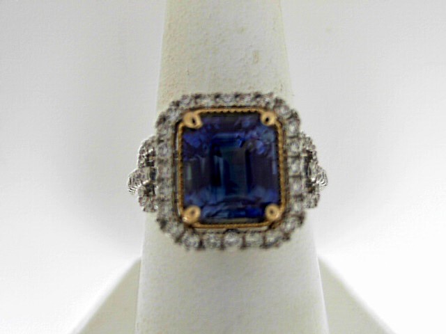 Platinum And 14 Karat Yellow Gold 4.23 Ct Emerald Cut Sapphire And 0.52 Ct Round Diamond Ring 
Size: 7