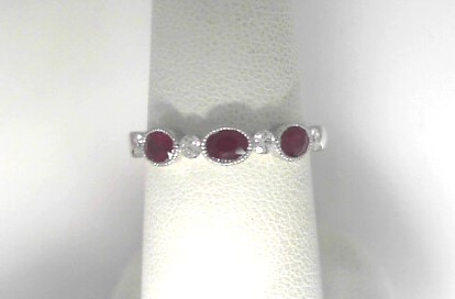 14 Karat White Gold Oval Ruby Wedding Band With Round Brilliant Diamonds 0.17Tw
Ring Size: 6.5
