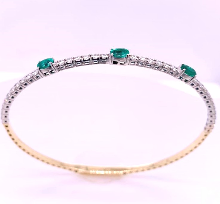 14 Karat Yellow/White Gold Flexible Bangle Bracelet With 3=0.73Tw Oval Emeralds And 34=0.83Tw Round  Diamonds
Length: 7