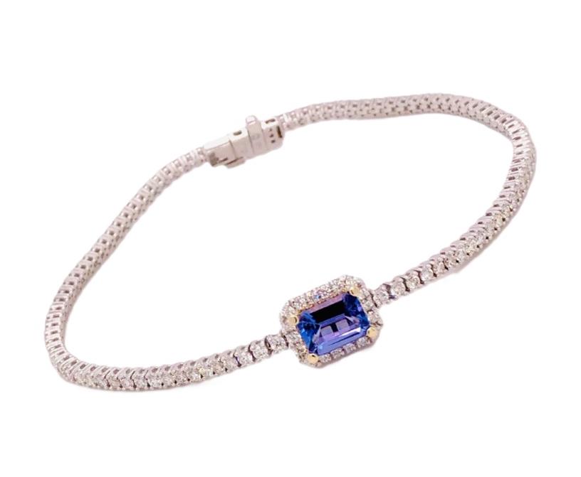 14 Karat White Gold Tennis Bracelet  With Center 1.18Ct Emerald Cut Tanzanite And 1.86Tw Roundi Diamond
Yellow Gold Prongs On Center
Length: 7