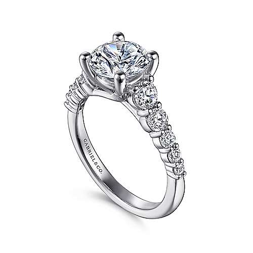 14kw .69ct Dia Semi-Mount    Astonishing 0.69ct accent diamonds in shared prong settings line the reverse tapered shank of this sophisticated engagement ring designed for a 1.5ct round center stone. The graduated diamonds create a look that is mo