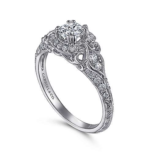 14kw .31ct Dia Semi- Mount    Beautifully crafted  this bold 14k white gold diamond engagement ring includes an exquisite halo and Victorian detailing that compliments your center stone.