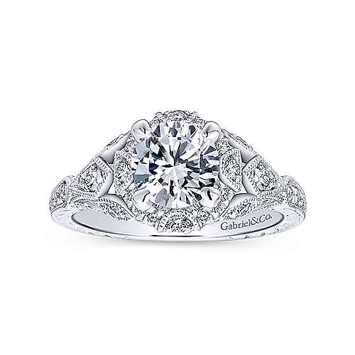 -14kw .35cttw Vintage Style Halo w/Engraved Shank and Milgrain Eng Ring Mounting    Milgrain accents within the diamond halo and around petal-shaped diamond clusters on the shoulders of the band add an heirloom feel to this stylish white gold engag