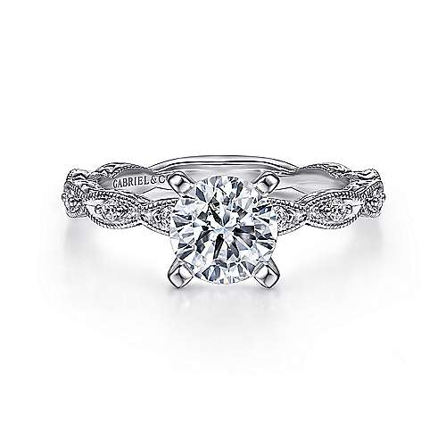14kw .12cttw Leaf Design w/ Milgrain and Engraved Shank Eng Ring Mounting    Elegant milgrain borders and handcrafted engraving speak to the vintage influences behind this captivating round cut engagement ring. The shape of the center stone contr