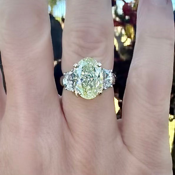 Estate Ring, 1 Oval Diamond 4.63 ct  Natural Fancy Green Yellow SI2 GIA 1232792484, 2 Half Moon Diamond 1.00 cttw  SI1-SI2, 18K/PLAT Yellow Gold 9.00g. All Weights Estimated.