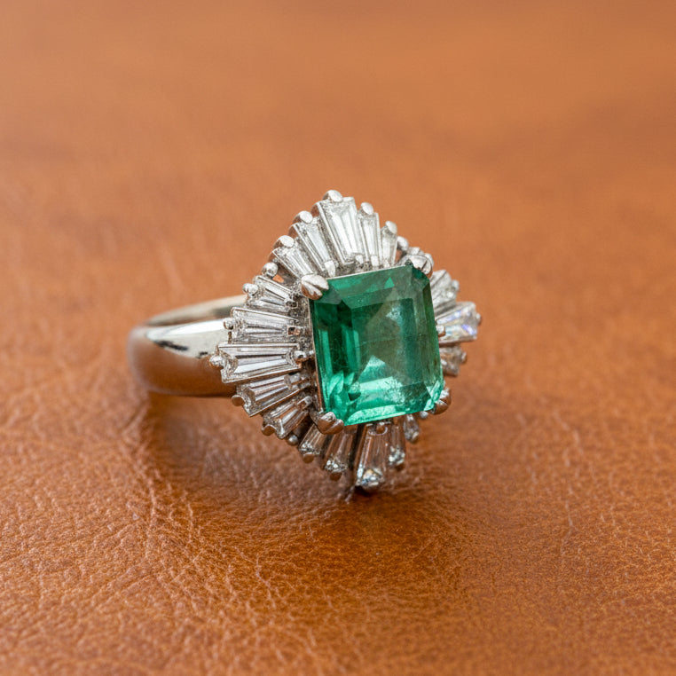Estate Ring, 20 Baguette Cut Diamonds 1.09ct H-J VS1-VS2, 1 Emerald Emerald Cut 2.65ct Green Columbia Minor Modern, Platinum 11.52g. All Weights Estimated.