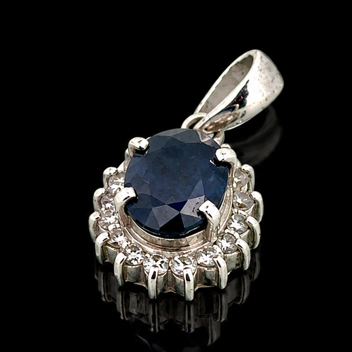 Estate Pendant, Round Brilliant Cut Diamond 0.20 cttw  G-H SI1-SI2,1 Sapphire Oval 0.97 ct  Platinum 1.52g. All Weights Estimated.