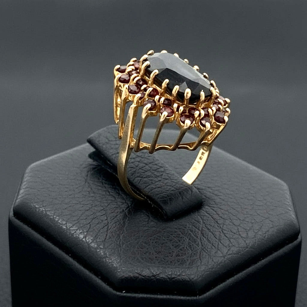 English MK Ring, 1 Garnet Oval 18.00ct, 38 Garnet Rounds 1.90cttw, 9KT Yellow Gold 12.50g. All Weights Estimated.