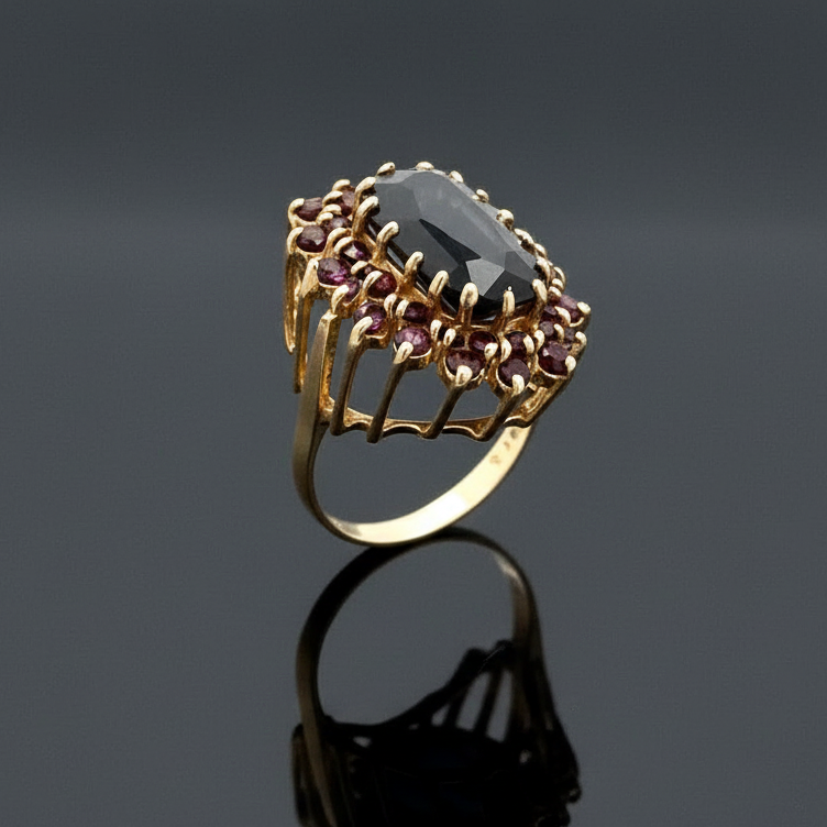 English "MK" Ring, 1 Garnet Oval 18.00ct, 38 Garnet Rounds 1.90cttw, 9KT Yellow Gold 12.50g. All Weights Estimated.