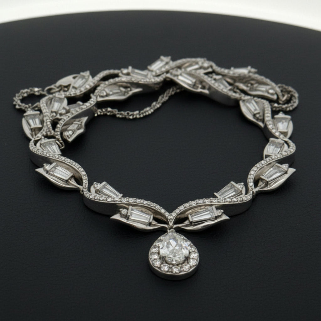 Estate Necklace, 1 Pear Shape Diamonds 1.15ct I-J VS2-SI1, Round/Baguette Cut Diamonds 5.00cttw H-I VS1-SI, Platinum 48.00g. All Weights Estimated.