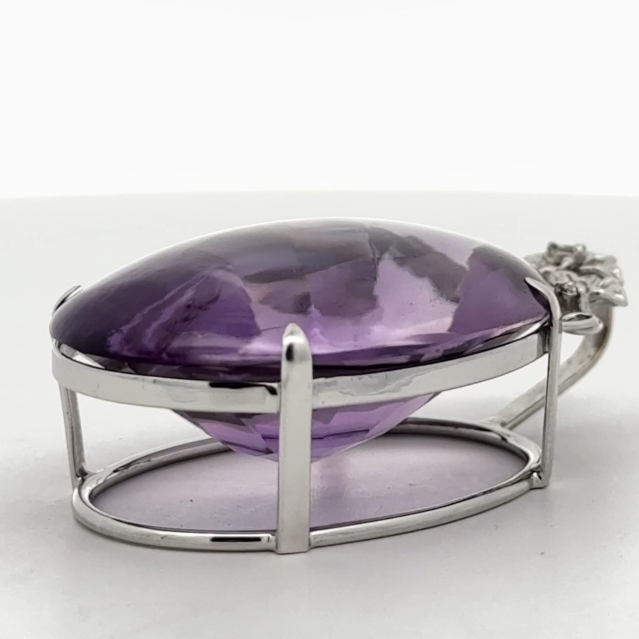 Pendant, 4 Round Brilliant Cut Diamonds 0.08cttw H-I SI1-SI2, 1 Amethyst Cabochon 58.41ct, 18K White Gold. All Weights Estimated.