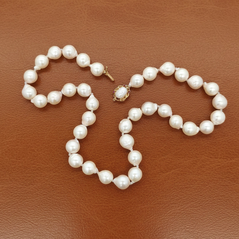 Estate Necklace, 38 South Sea Pearl Color White-Light Rose Baroque Cut 9-9.5mm, 1 Biwa Freshwater Pearl 8mm, 14K Yellow Gold. All Weights Estimated.