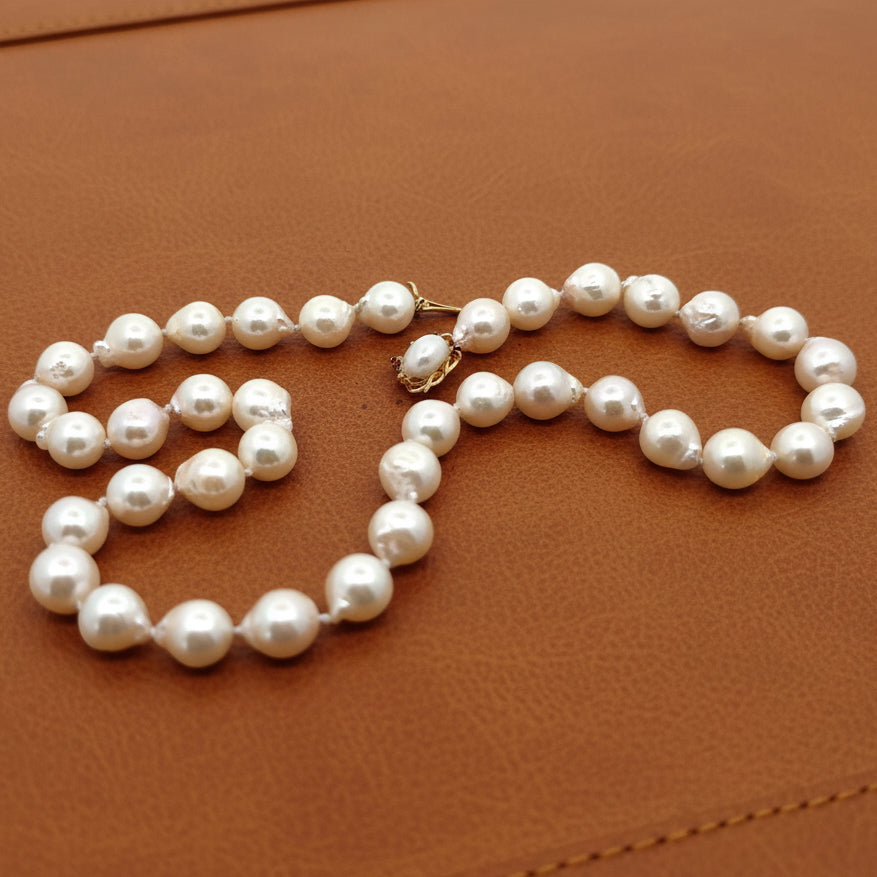 Estate Necklace, 38 South Sea Pearl Color White-Light Rose Baroque Cut 9-9.5mm, 1 Biwa Freshwater Pearl 8mm, 14K Yellow Gold. All Weights Estimated.