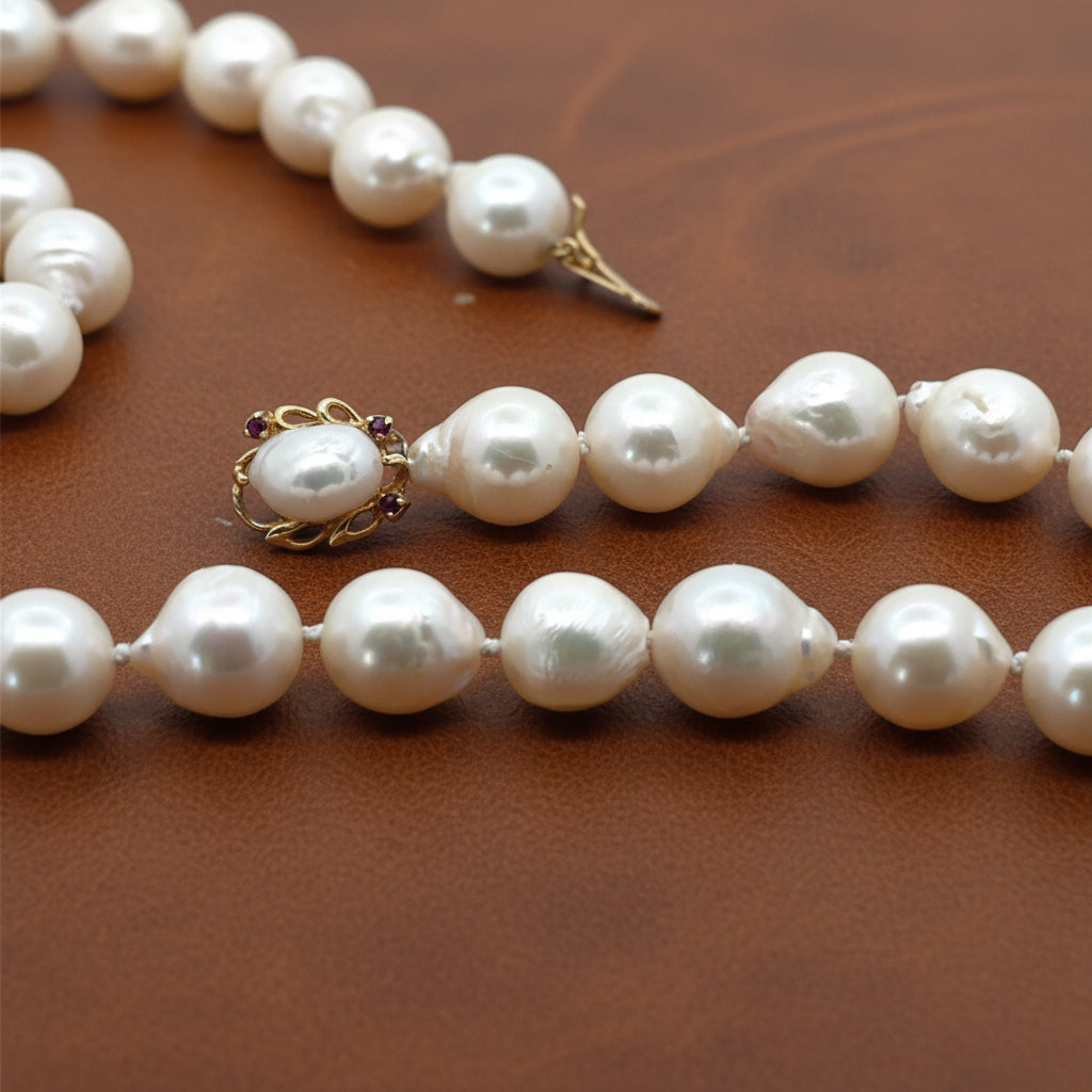 Estate Necklace, 38 South Sea Pearl Color White-Light Rose Baroque Cut 9-9.5mm, 1 Biwa Freshwater Pearl 8mm, 14K Yellow Gold. All Weights Estimated.