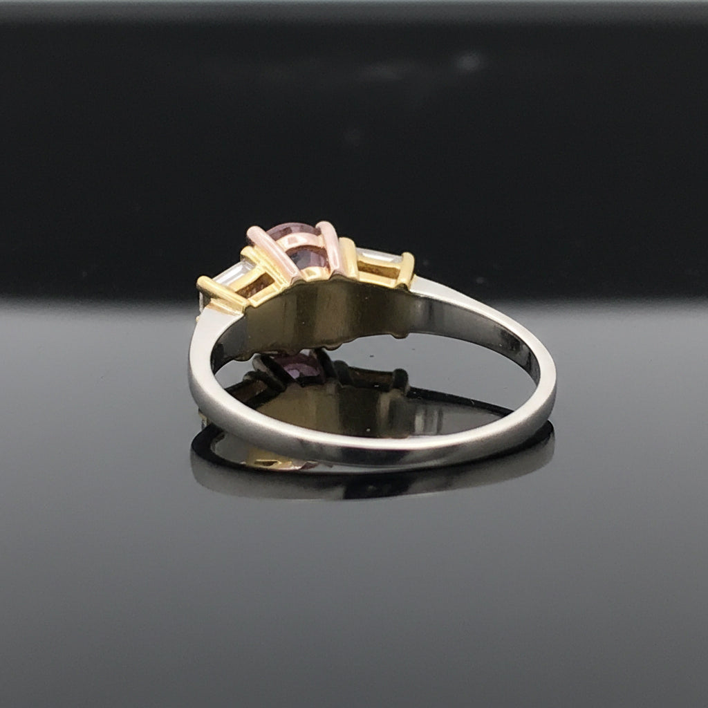 Estate Ring, 1 Oval Diamond 0.61 ct  Fancy Purple-Pink I1 GIA #14336063, 2 Trapezoid Cut Diamond 0.52 cttw  FY VVS1-VVS2 Platinum/18K Yellow/Rose Gold 3.43g. All Weights Estimated.