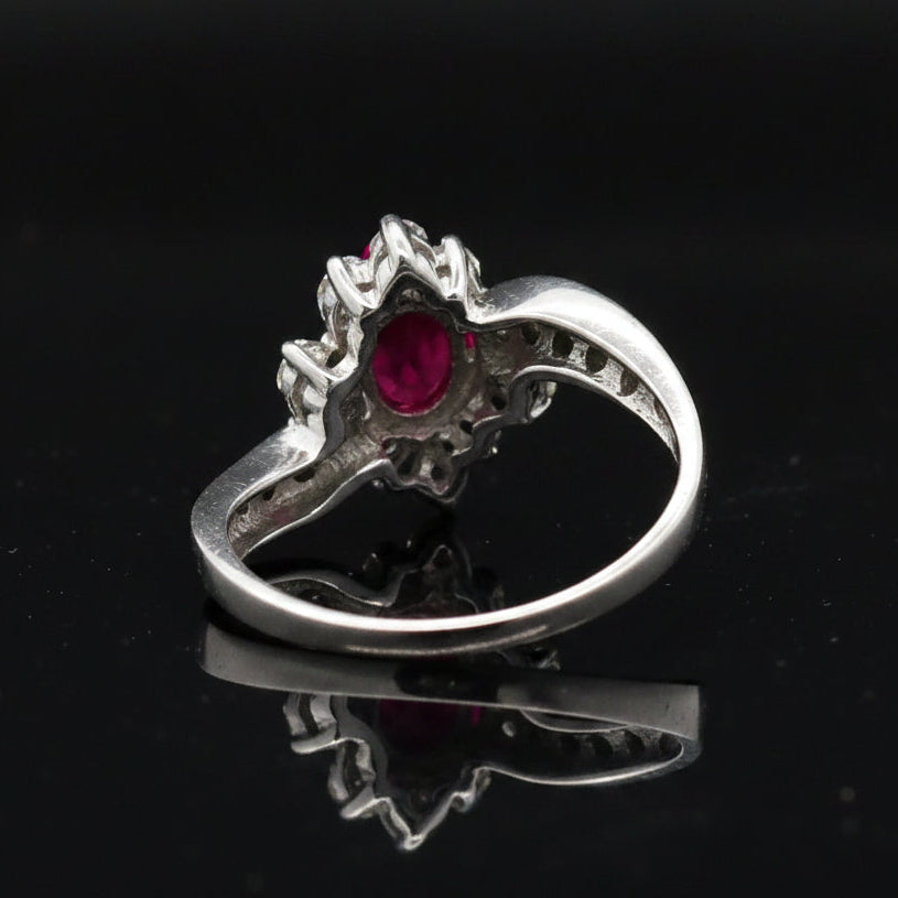 Estate Ring, 20 Round Brilliant Cut Diamond 0.25 cttw  G-H VS1-SI1,1 Ruby Oval 0.51 ct  18K White Gold 3.76g. All Weights Estimated.