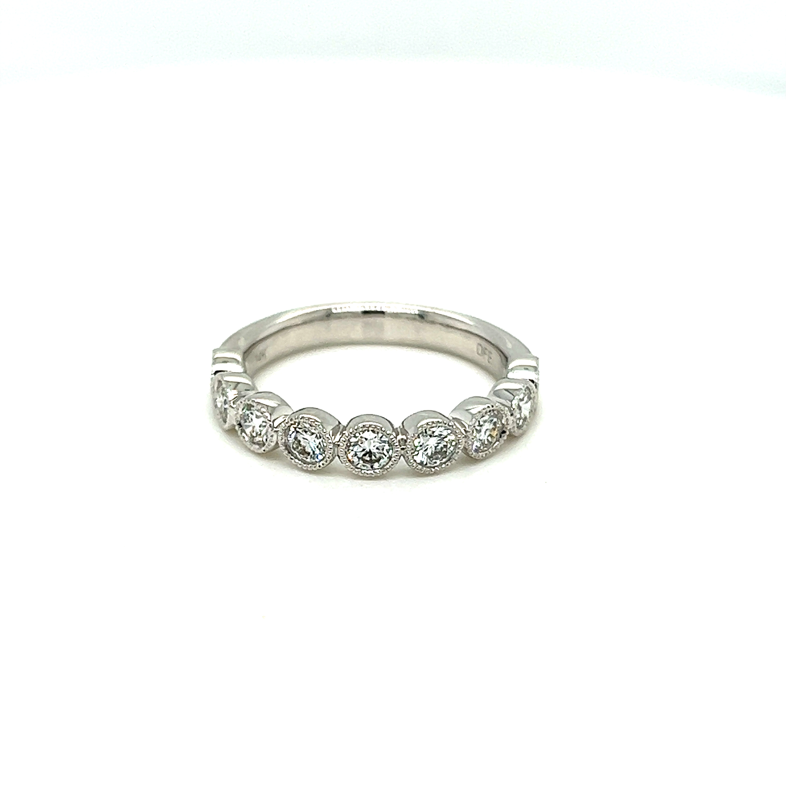 14 Karat white gold bezel set wedding band with milgraining and 9=0.80tw Round Brilliant G VS Diamonds