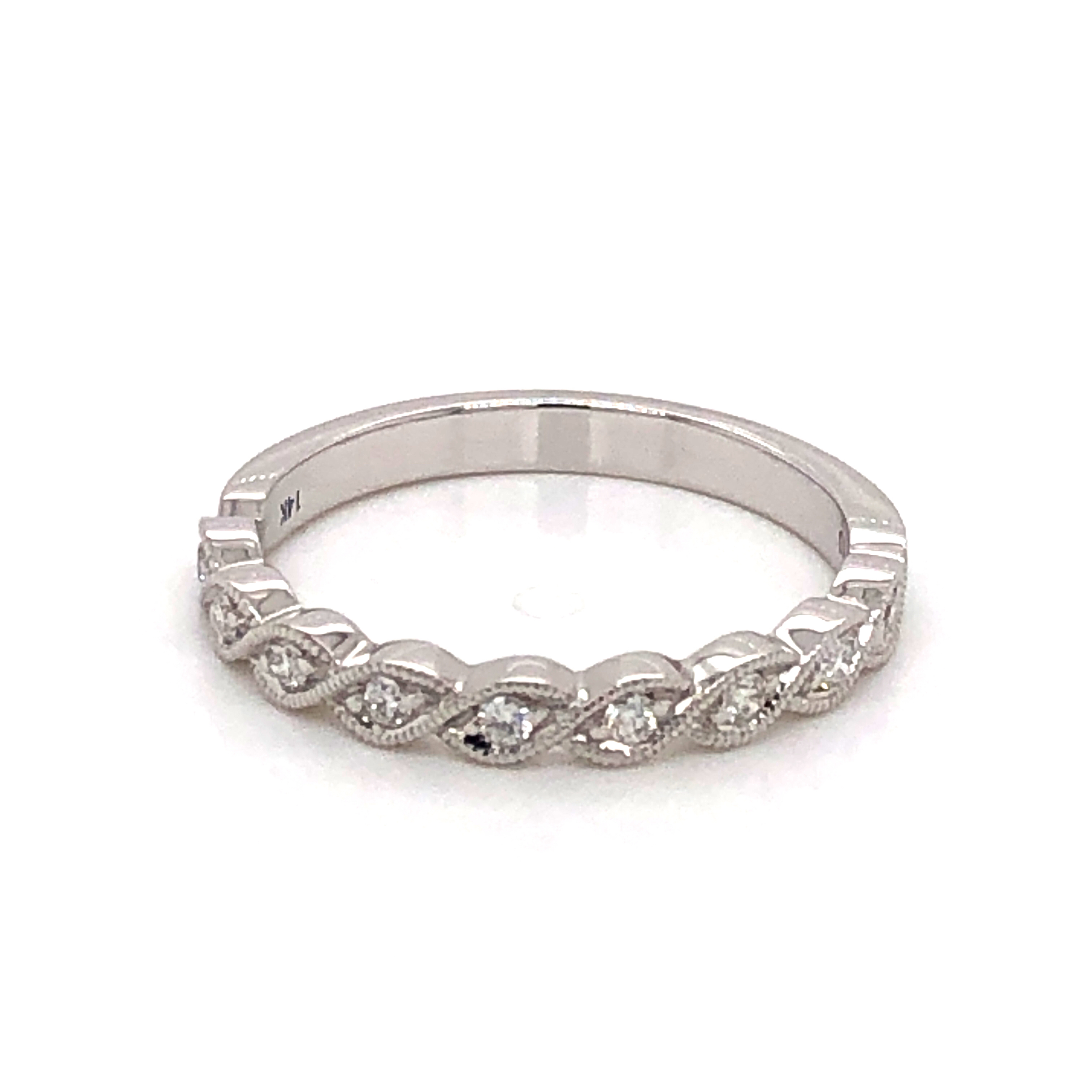 14 karat white gold wedding band with 9=0.12 total weight round brilliant G VS Diamonds. Size 6.5