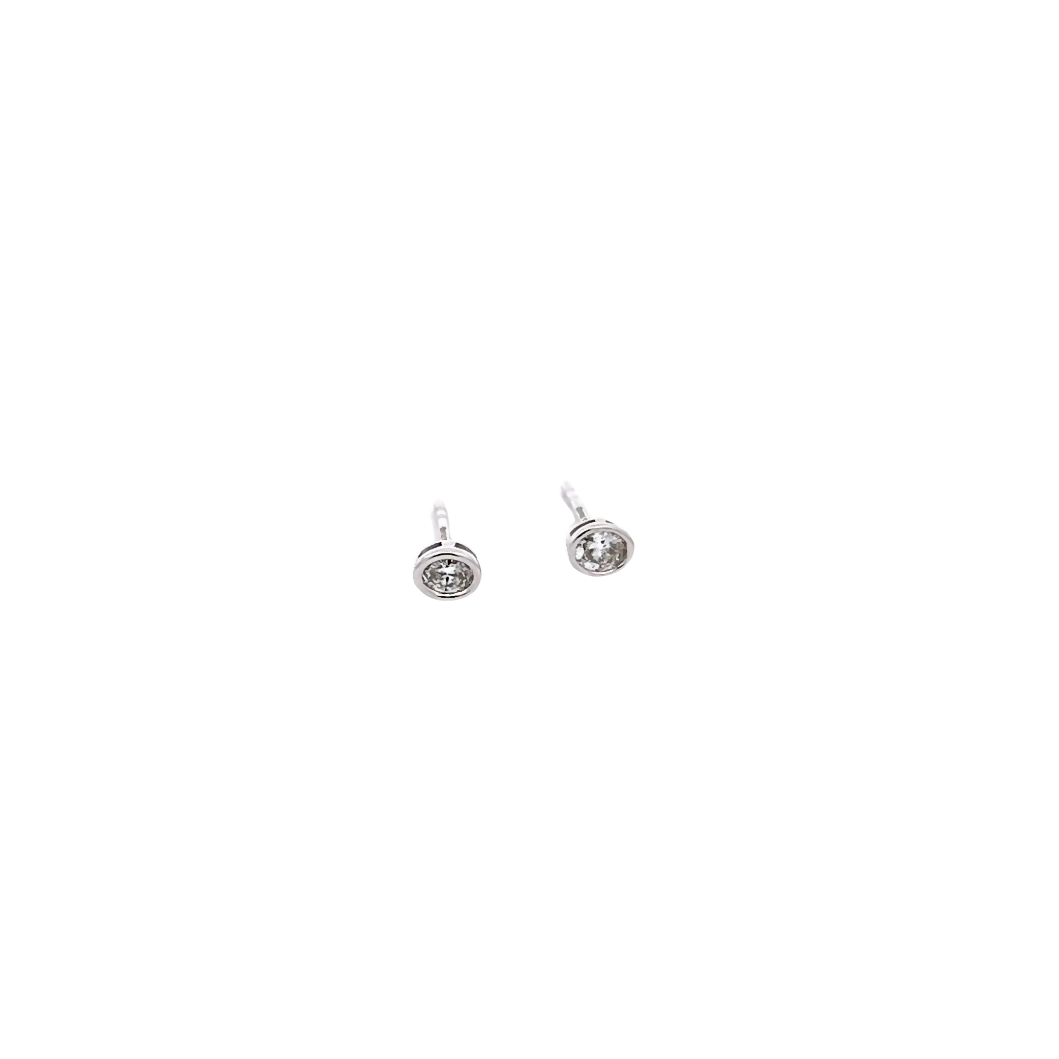 14 Karat white gold stud earrings with 2=0.19 total weight bezel set oval J VS Diamonds