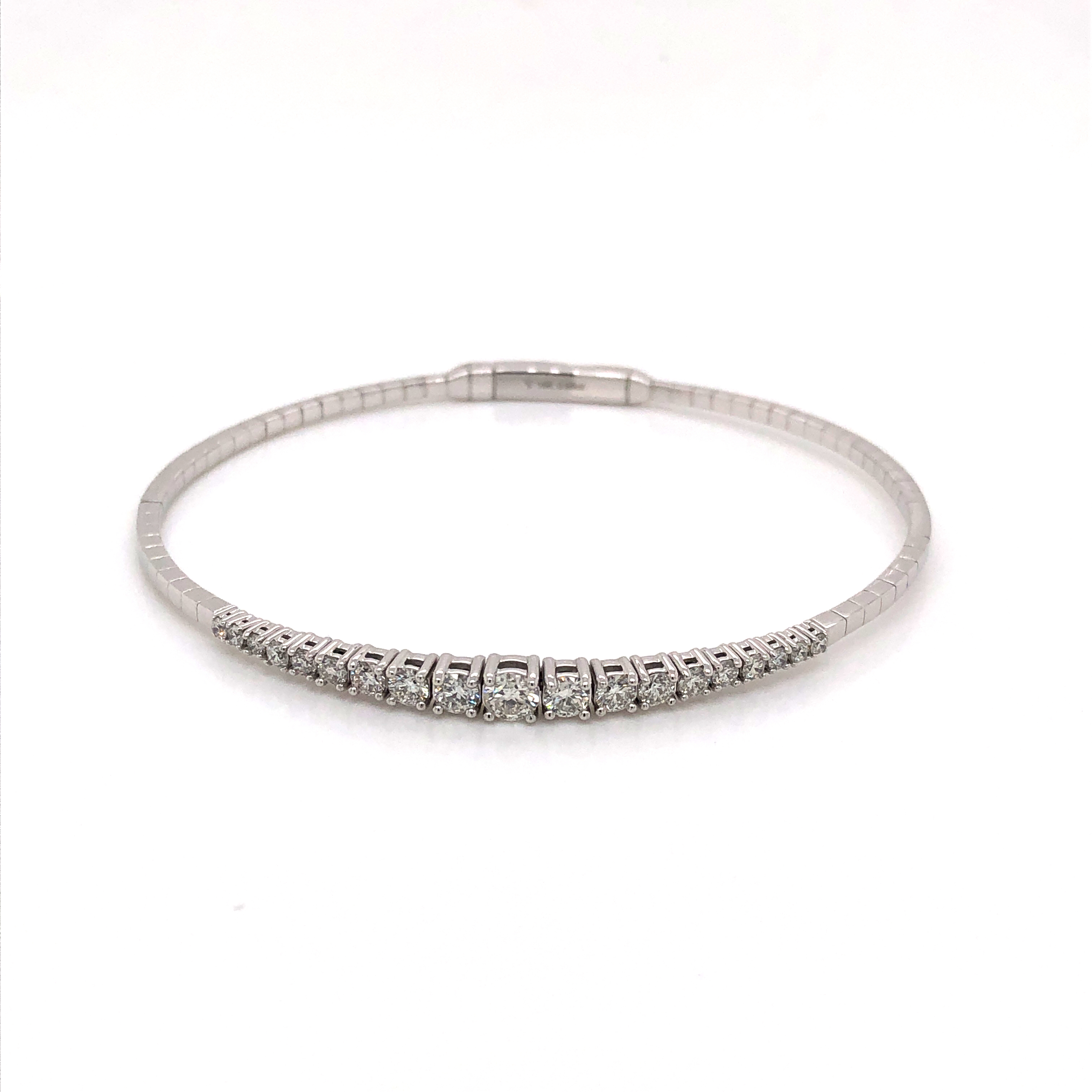 14 karat white gold flexible bangle bracelet with nineteen round brilliant diamonds graduating in size totaling 0.95 carat total weight G color  SI  clarity.