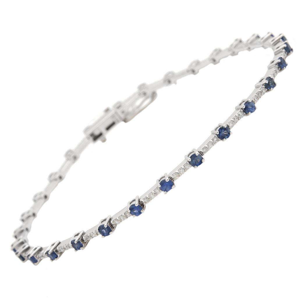 14 karat white gold line bracelet with 87=0.46tw round brilliant G I Diamonds and 29=1.68tw round mixed cut Sapphires