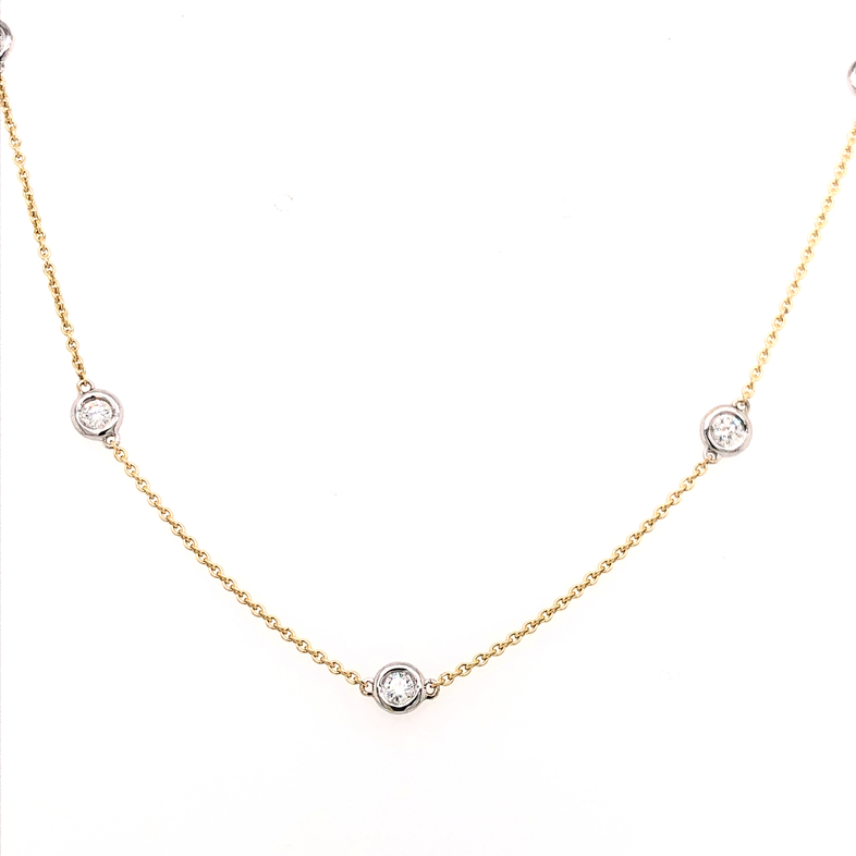 14 Karat yellow gold diamonds by the yard necklace Length 19" with 5=0.30ctw Round Brilliant G SI Diamonds set in white gold.
