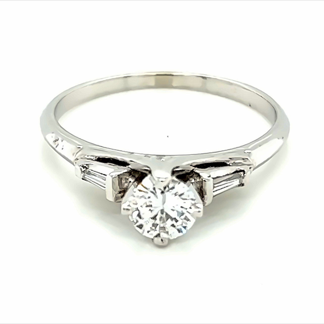 14 Karat White Gold Engagement Ring with One 0.45ct Round Brilliant K VS1 Diamond and  2=0.10tw Baguette G VS Diamonds.