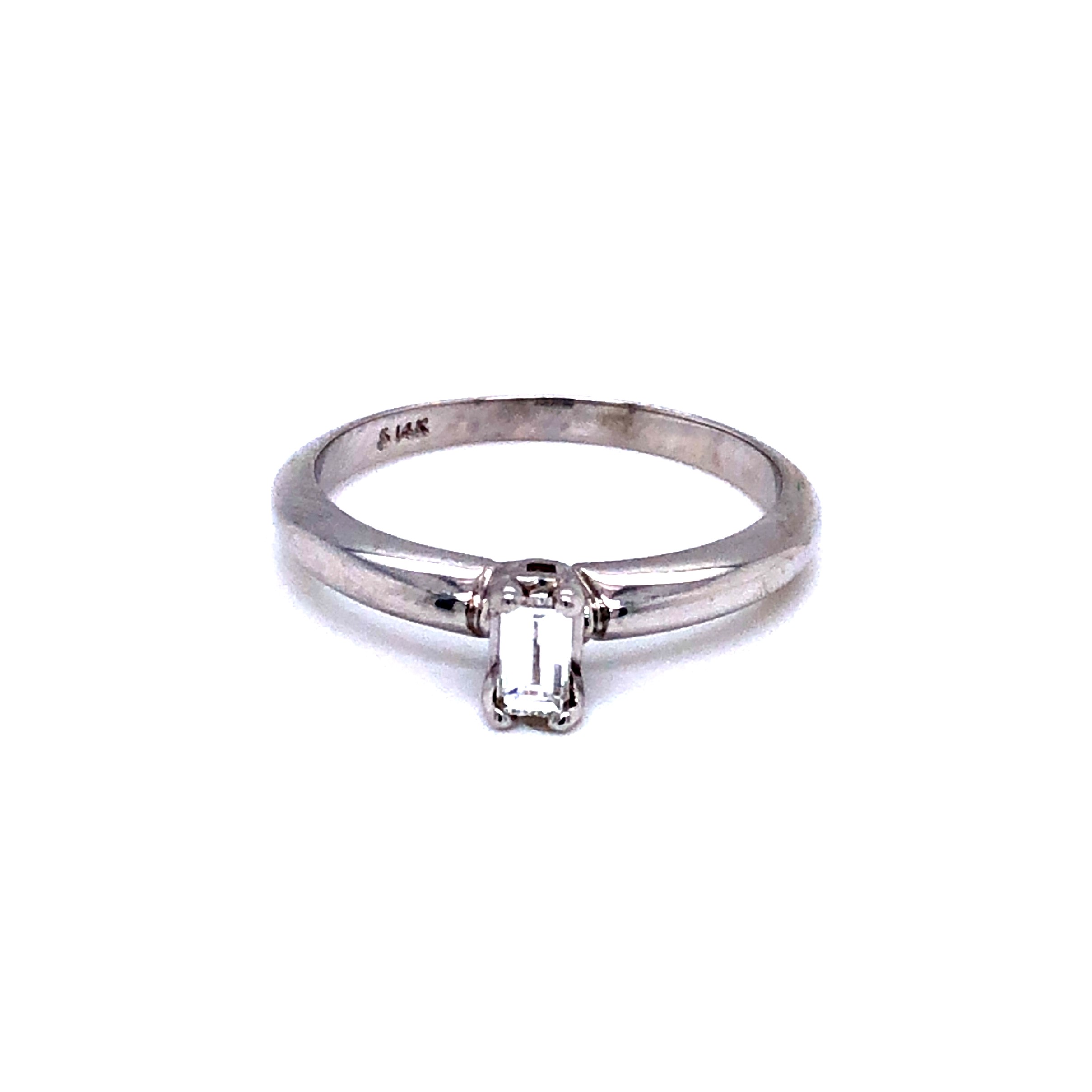 Ladies 14 karat white gold solitaire engagement ring with an Emerald cut diamond weighing 0.18 carat  F color  VS1 clarity.