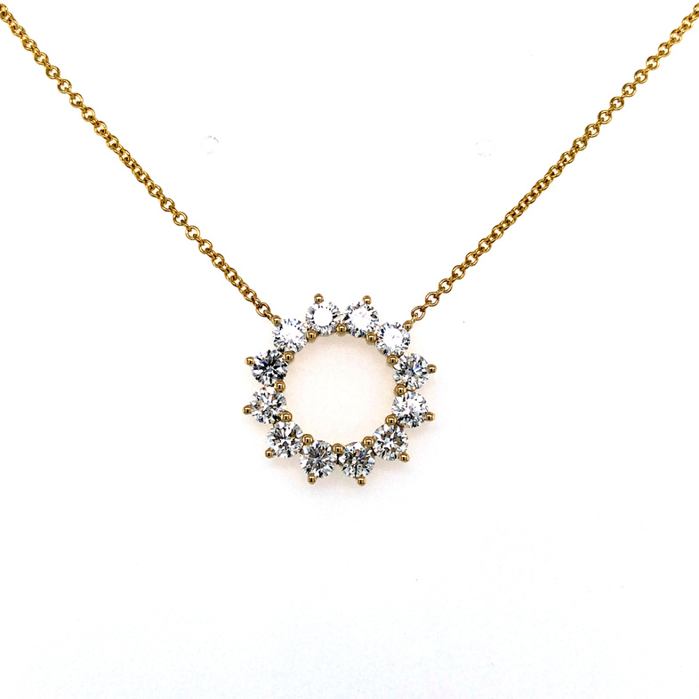 14 karat yellow gold circle pendant with 12=1.50 total weight round brilliant F VS Diamonds.