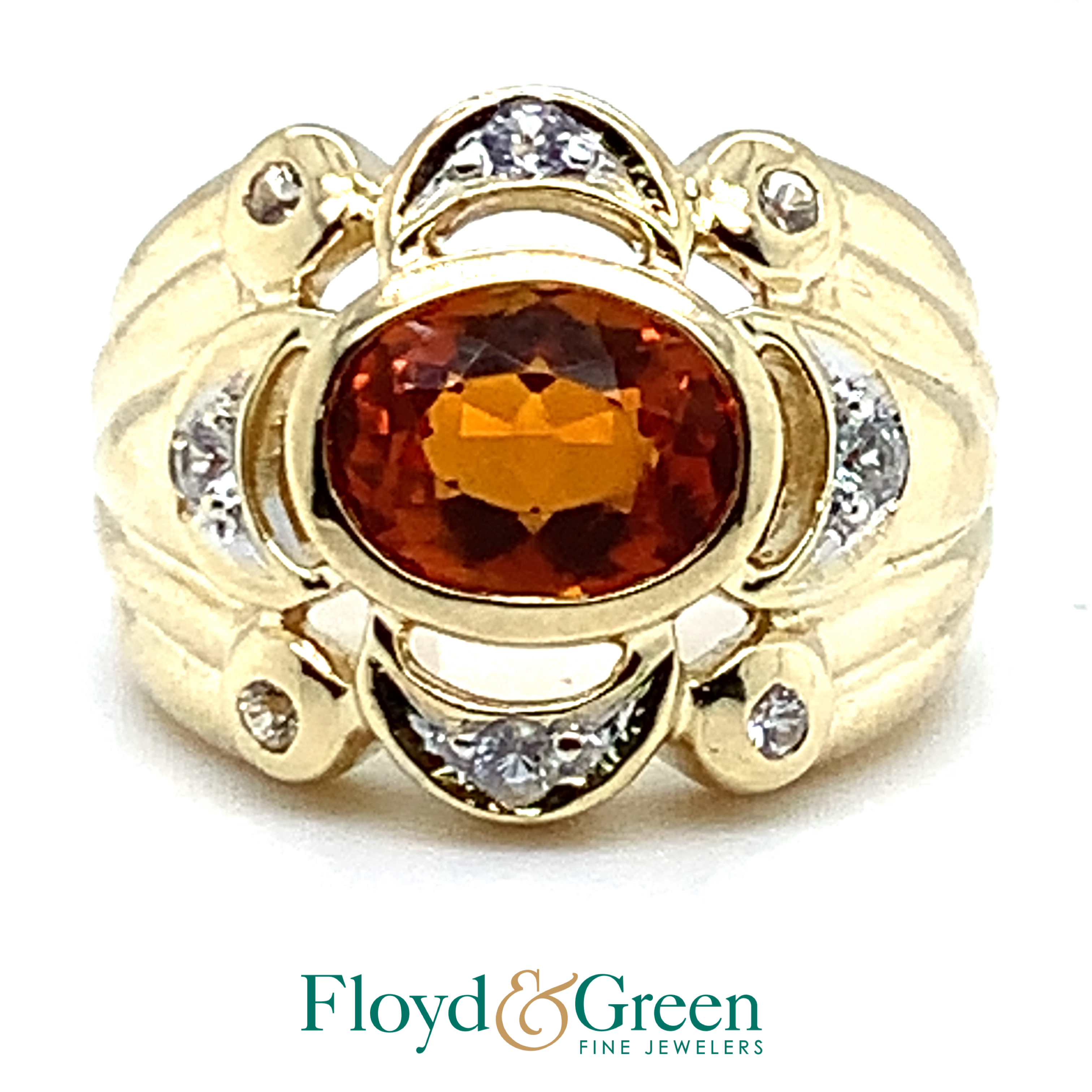yellow oval orange stone with clear stones ring