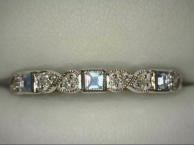 10 KARAT WHITE GOLD STACKABLE RING SIZE 7 WITH 6=0.09TW ROUND I COLOR I1 CLARITY DIAMONDS AND 3=0.23TW PRINCESS BLUE TOPAZS   (1.43 GRAMS)