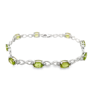 STERLING SILVER INFINITY BRACELET LENGTH 7.25 WITH 9=7.45TW OVAL PERIDOTS AND 18=0.08TW ROUND DIAMONDS