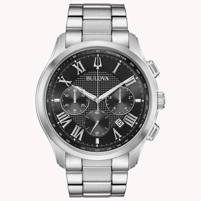 MEN'S BULOVA WILTON STYLE WITH SIX-HAND CHRONOGRAPH FUNCTION. STAINLESS STEEL CASE WITH APPLIED ROMAN MARKERS  TACHYMETER AND CALENDAR FEATURE ON BLACK TEXTURED DIAL  DOMED MINERAL GLASS  THREE-ROW STAINLESS STEEL BRACELET WITH DOUBLE-PRESS DEPLOYMENT