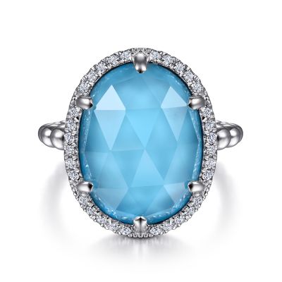 BUJUKAN COLLECTION STERLING SILVER BEADED HALO RING SIZE 6.5 32=0.25TW ROUND WHITE SAPPHIRES AND ONE 16.00X12.00MM OVAL ROCK CRYSTAL & SIMULATED TURQUOISE   (6.54 GRAMS)