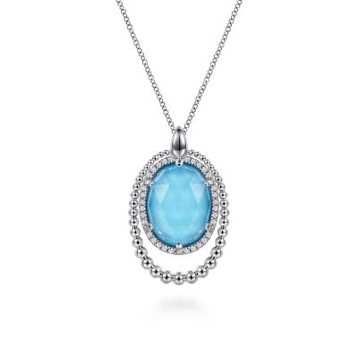 BUJUKAN COLLECTION STERLING SILVER BEADED HALO PENDANT WITH 32=0.26TW ROUND WHITE SAPPHIRES AND ONE OVAL 16.00 X 12.00MM ROCK CRYSTAL & SIMULATED TURQUOISE 17.5