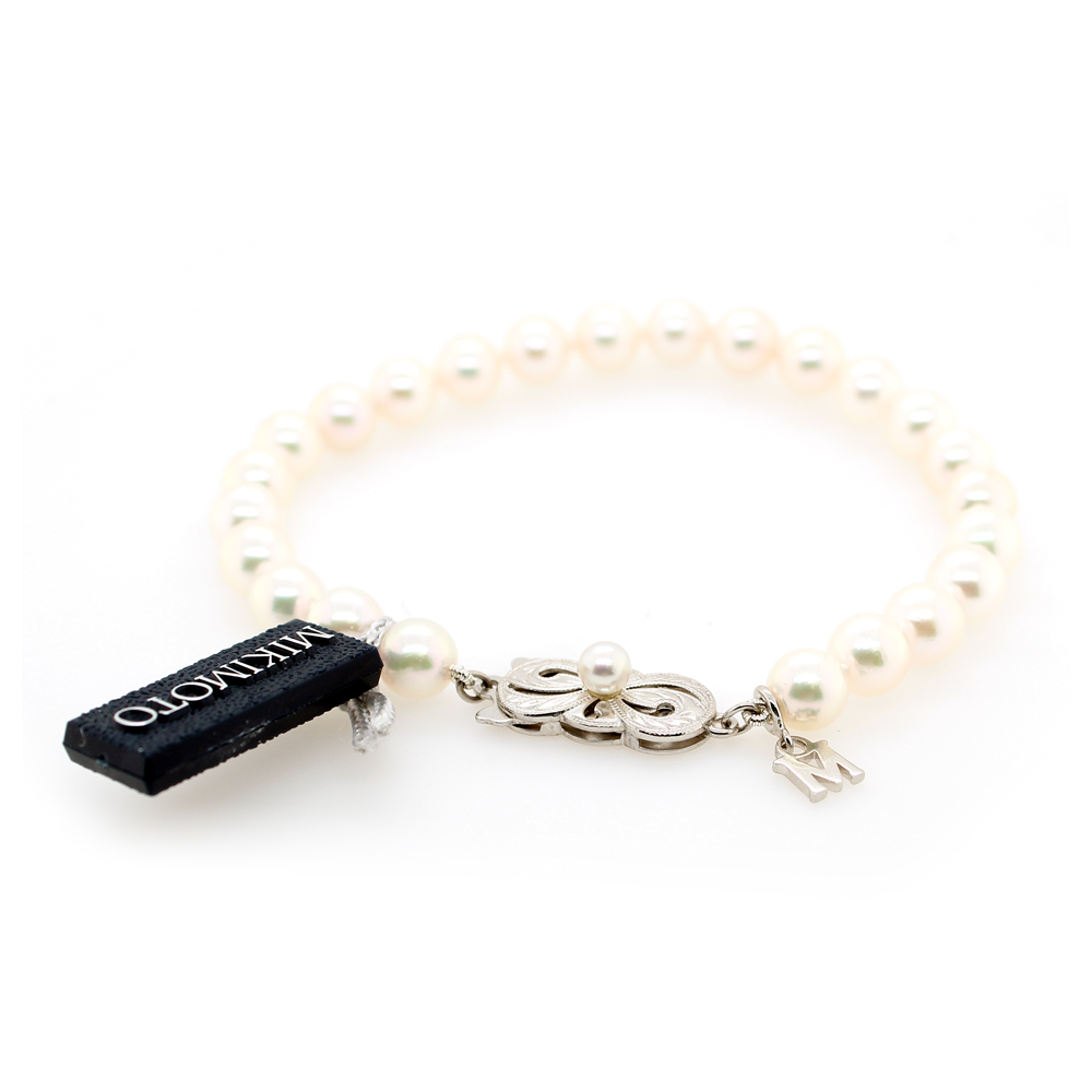 Mikimoto 18 karat white gold single strand cultured pearl bracelet  7" long  having cultured pearls measuring 6-1/2 x 6mm of A quality and an 18 karat white gold signature clasp.