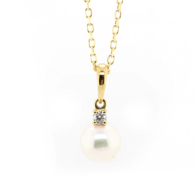 Mikimoto 18 Karat Yellow Gold Pearl And Diamond Pendant Having A Smooth Bail With 1 Full Cut Diamond Weighing Approximately 0.05 Carat And Graded F For Color And VS1 For Clarity Prong Set Connected To An 'AA' Quality White Pearl On A Flat Oval Link Chain