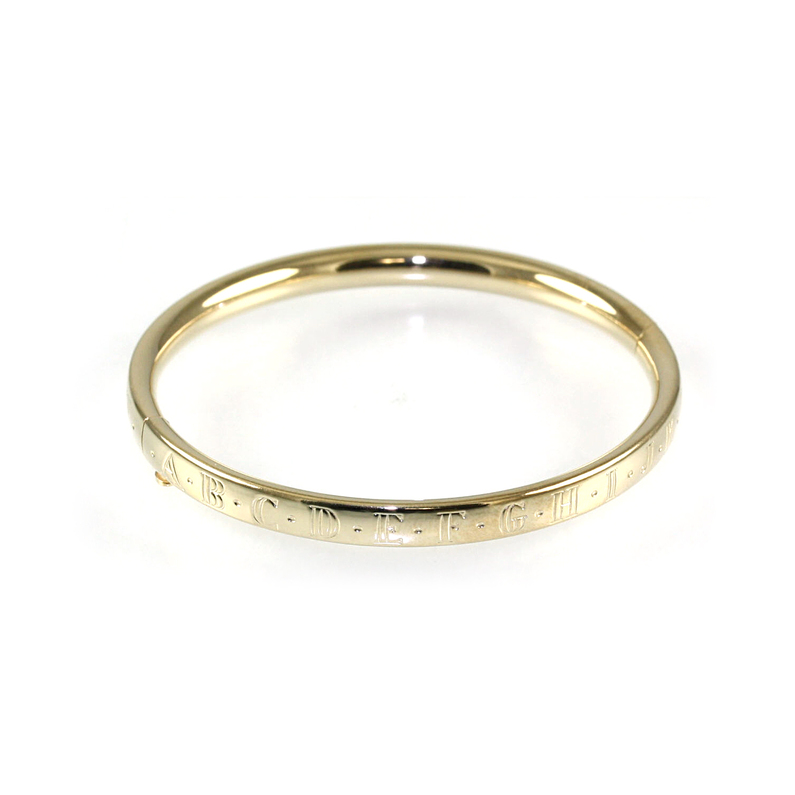 Kiddie Kraft 14 Karat Yellow Gold Filled Hinged Bangle Bracelet With The Alphabet Engraved On The Outer Edge.