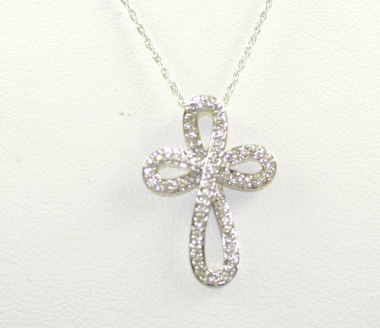14 Karat White Gold Diamond Cross Pendant Suspended On A 16" Diamond Cut Oval Link Chain With Spring Ring Clasp