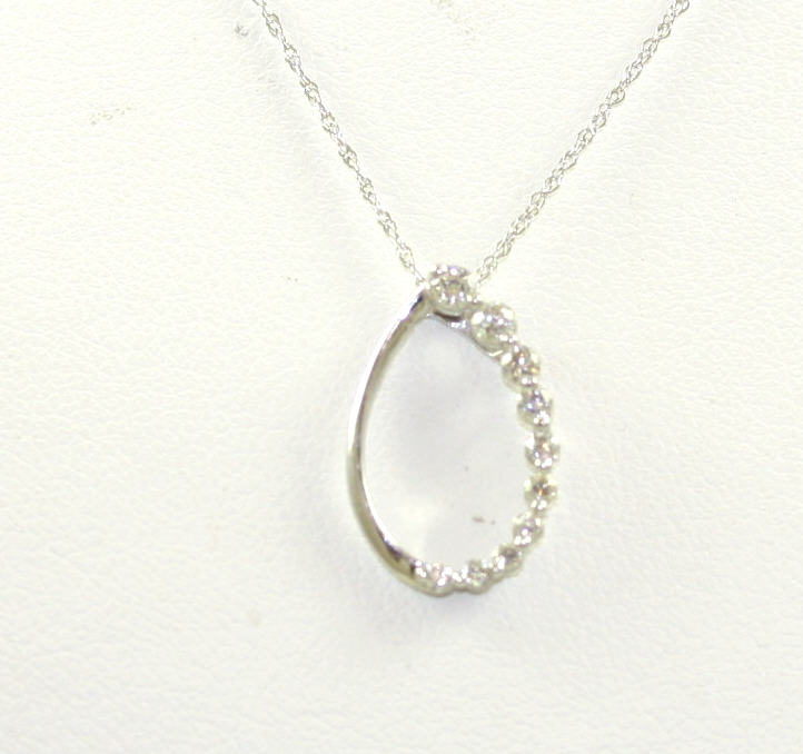 LADY'S 14KWG DIA OVAL PENDANT HAVING ONE POLISHED SIDE AND ONE SIDE WITH GRADUATED FULL CUT PRONG SET DIAMONDS