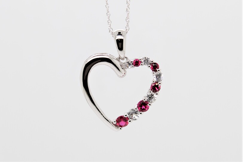 Estate lady's fourteen karat white gold ruby and diamond cutout heart pendant suspended on 14kwg fine rope chain measuring 18