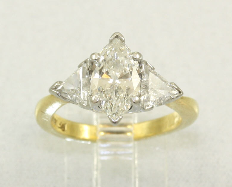 Estate 18 Karat Yellow Gold Diamond Ring Having 1 Marquise Cut Diamond Prong Set In Platinum Head In The Center With 1 Trillion Cut Diamond Prong Set On Either Side