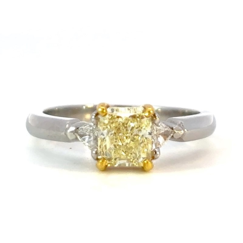 Estate Platinum Diamond Ring Having 1 IGI Certified Radiant Diamond Weighing 1.02 Carats  VS1-VS2 Natural Fancy Yellow Color  With 1 Trillion Diamond On Either Side Having A Combined Weight Of .12 Carat VS1-G Natural Fancy Yellow Center Stone Mounted In 2