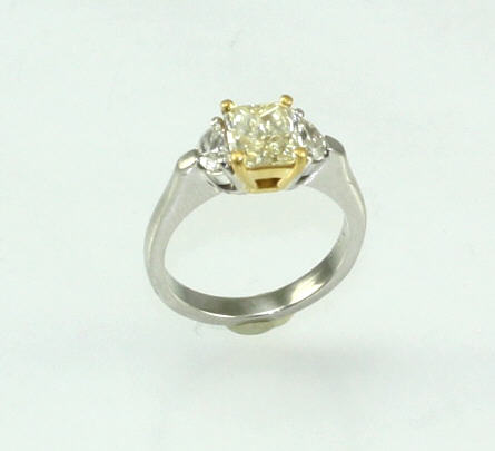 Estate Platinum Diamond Ring Having 1 IGI Certified Radiant Diamond Weighing 1.13 Carat  VVS1-VVS2 Natural Fancy Light Yellow Color  With 1 1/2 Moon On Either Side Having A Combined Weight Of .32 Carat VS1-G Natural Fancy Light Yellow Center Stone Mounted