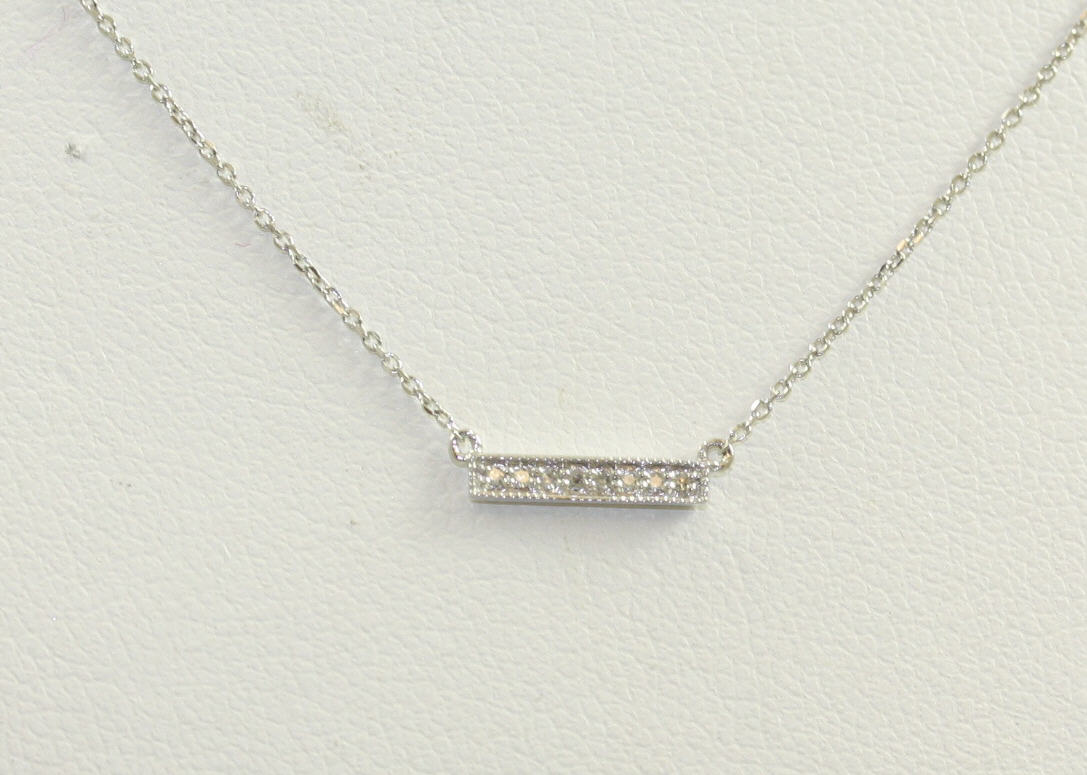 14 karat white gold diamond bar pendant suspended on a attached oval link 16-18" chain w/spring ring clasp