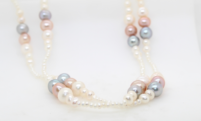 Endless multi color pearl necklace having 12 stations each with white  pink and gray pearls alternating with a section of 3mm white pearls