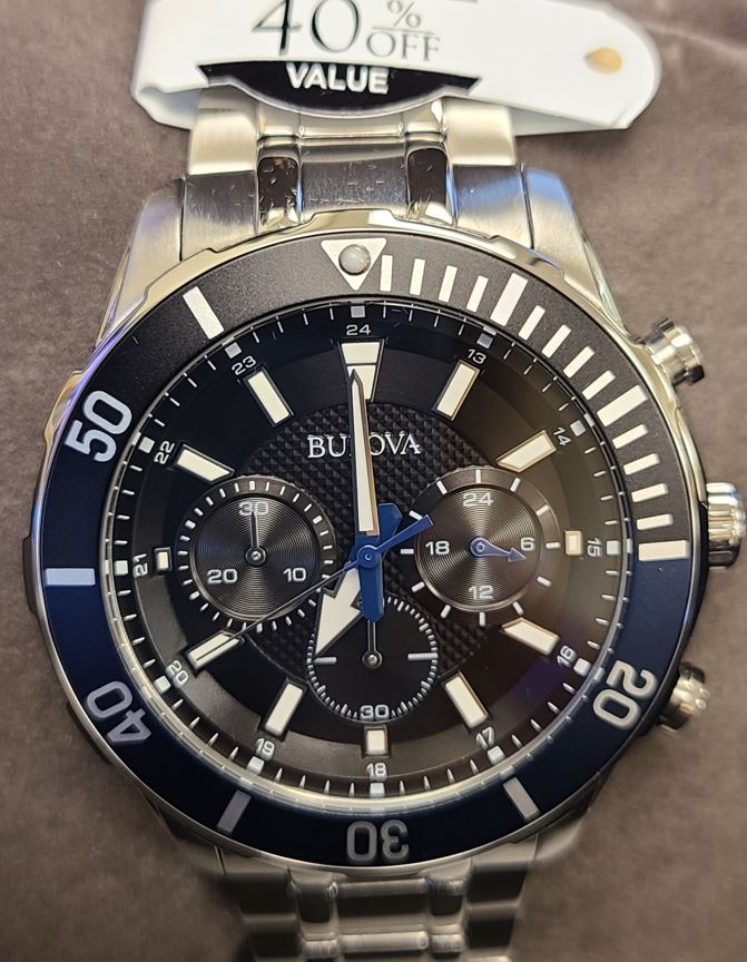 Bulova gents stainless steel timepiece. The watch contains a black Chronograph marker dial with a black time lapse unidirectional bezel and a ss link bracelet.