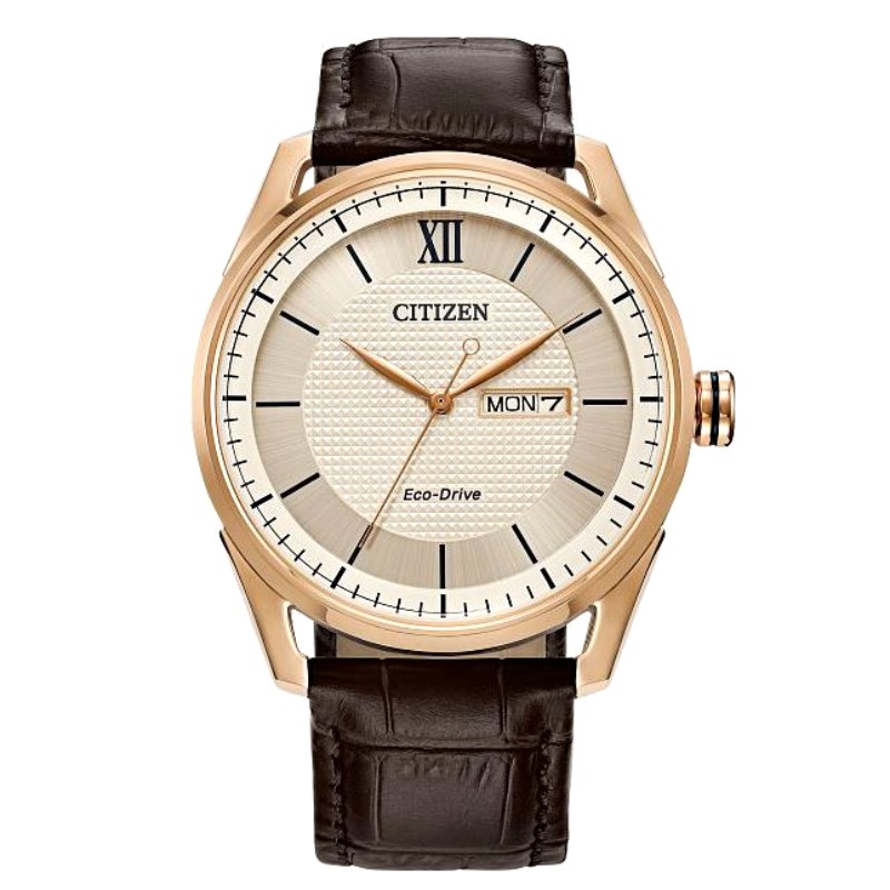 Citizen Corso gold tone stainless steel 42mm case has a silver stick date dial polished bezel and mineral crystal. The watch has an Eco Drive movement and a brown leather strap..