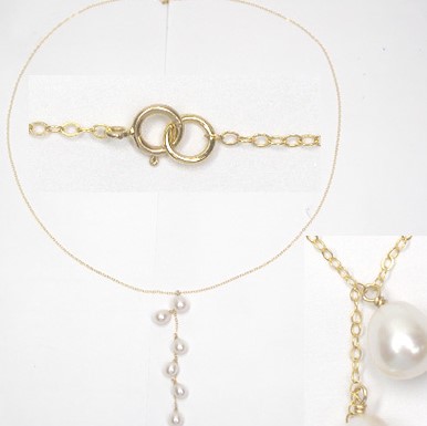The oval link chain has a center dangle section with 6 pearls ranging in size from 8 to 8.5 mm.